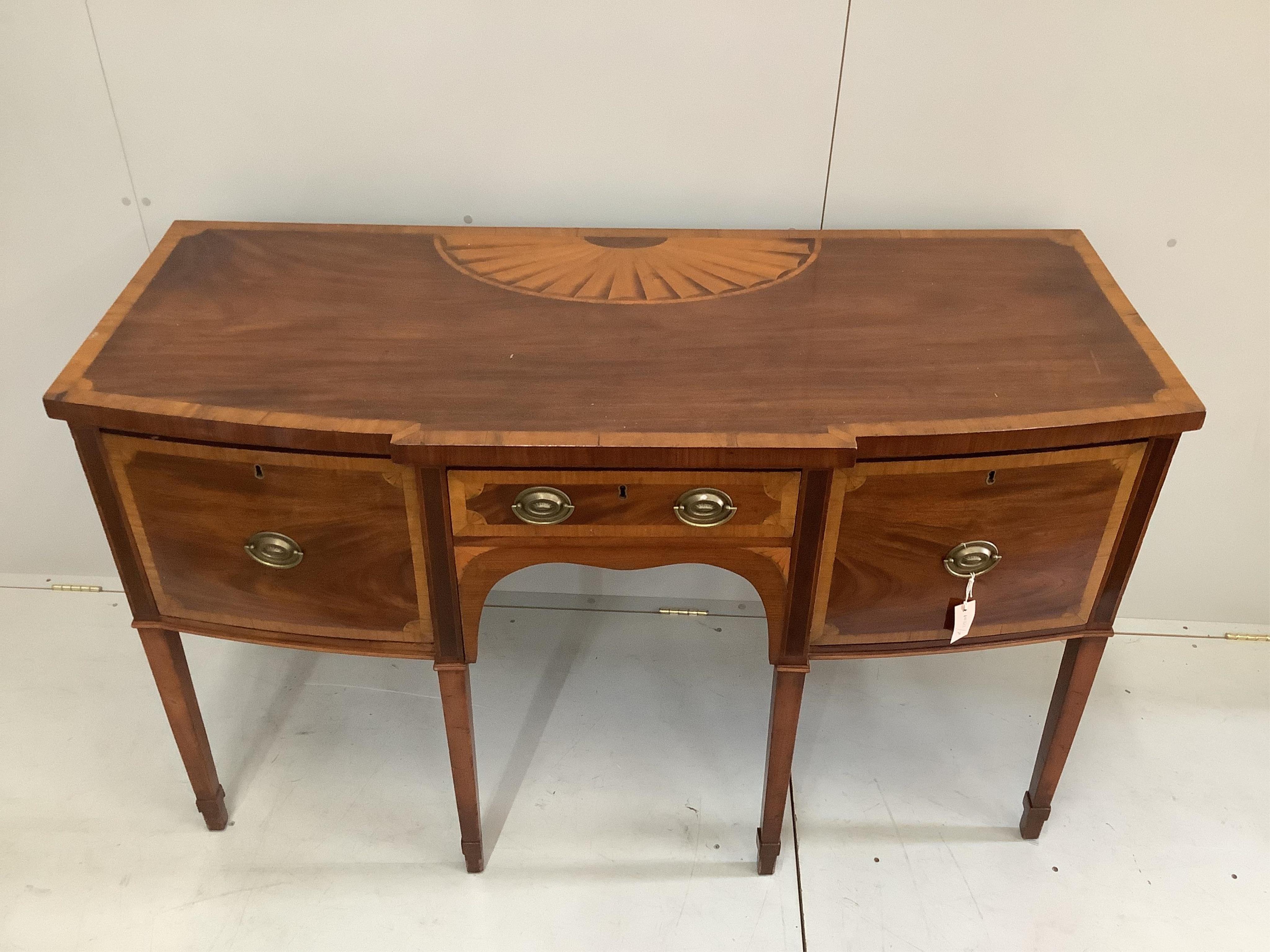 A George III paterae inlaid and satinwood banded mahogany breakfront sideboard, width 152cm, depth 64cm, height 92cm. Condition - fair